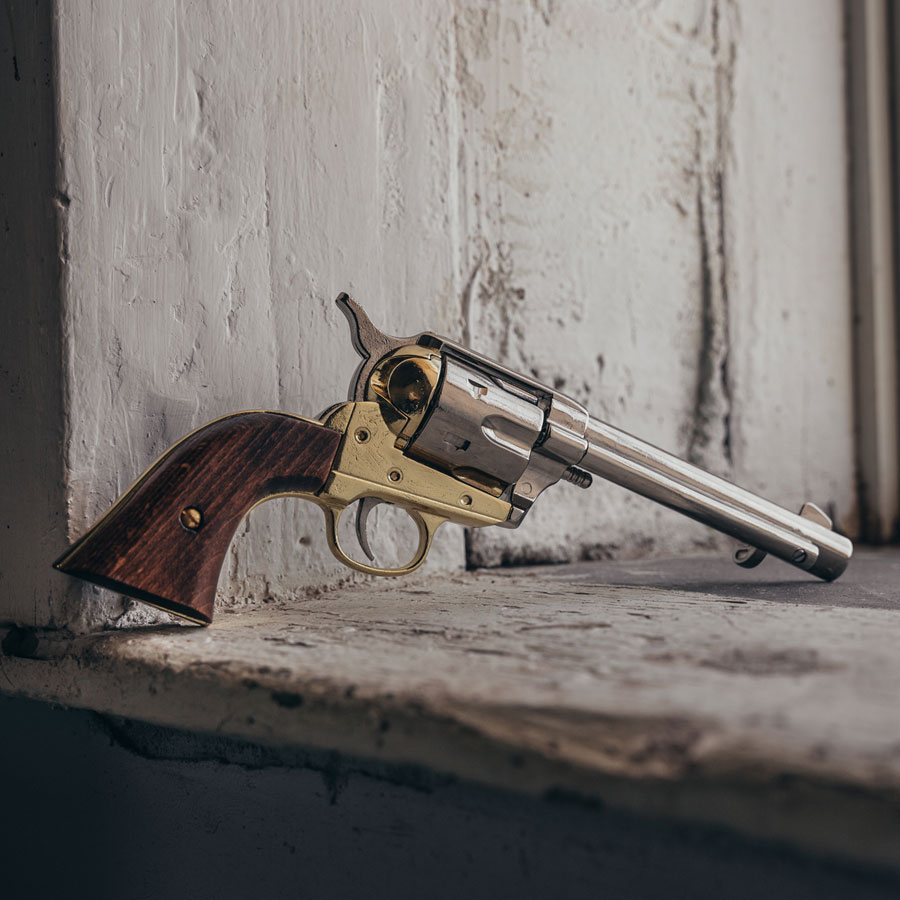 old west replica pistol leaning against a wall