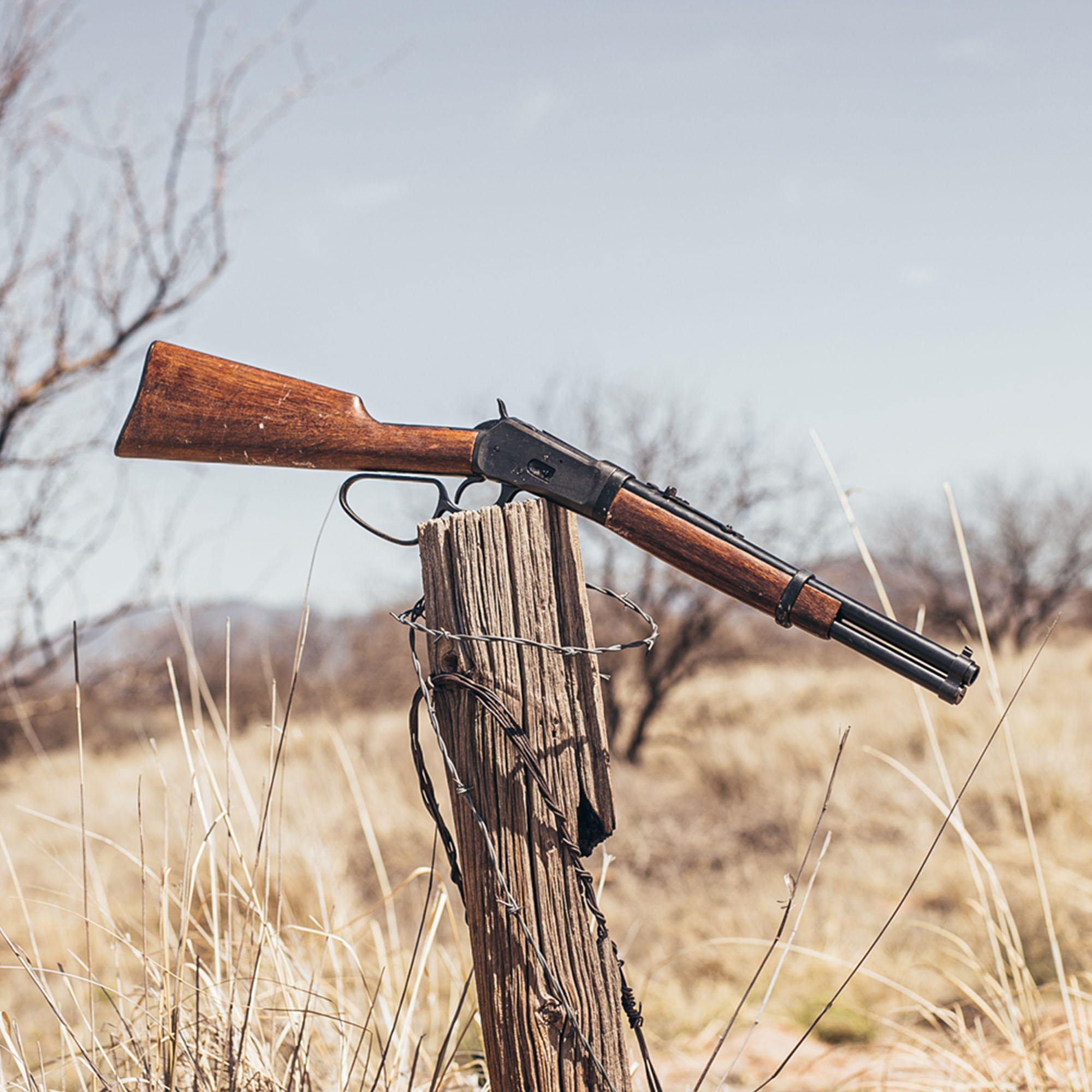 replica 1892 old west rifle on a fence post