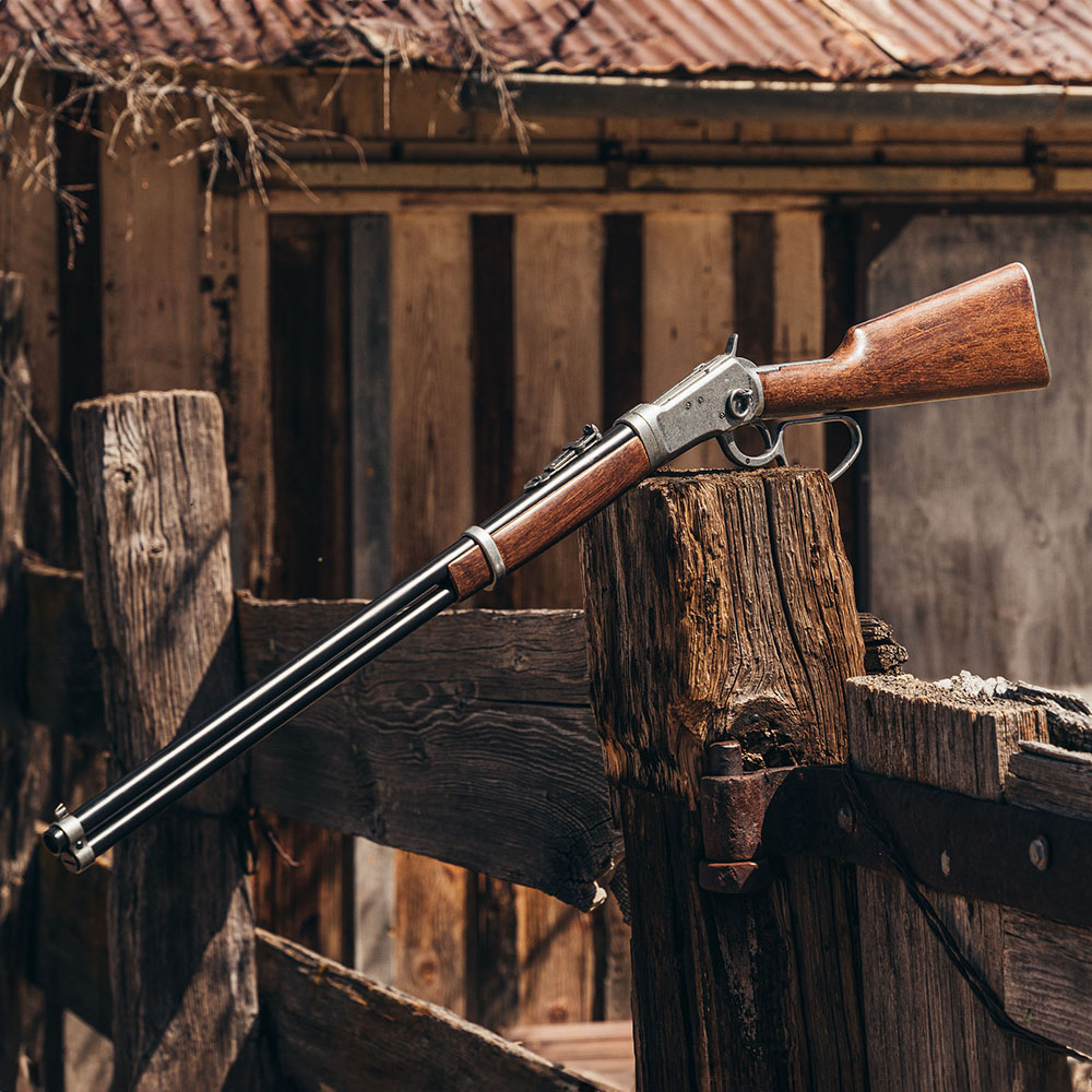non firing old west rifle replica on rail fence