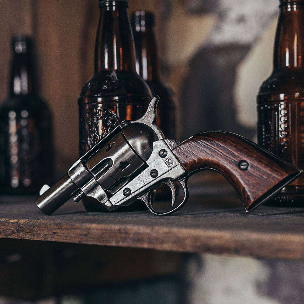 non firing 1873 45 caliber short revolver on a table