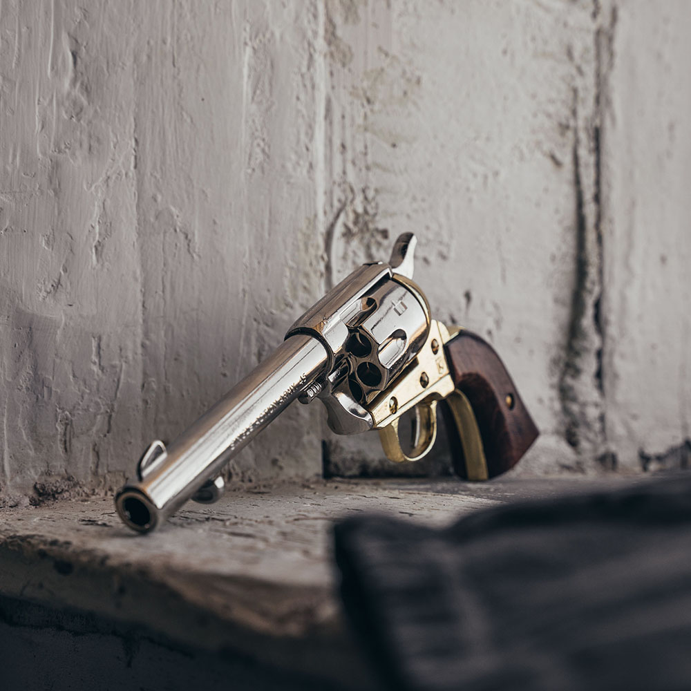 wood handle 45 replica peacemaker revolver on a window ledge