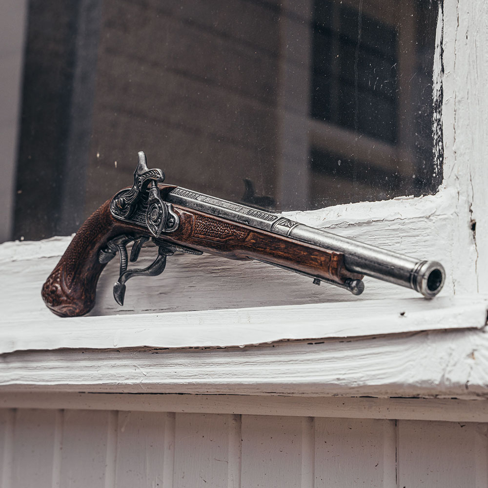 replica pirate percussion pistol on window ledge