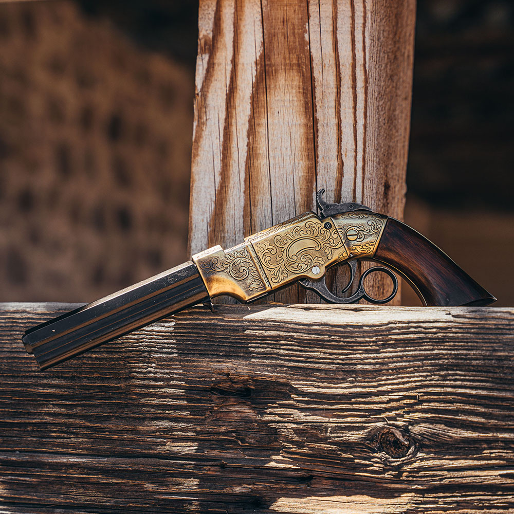 volcanic pistol replica on wooden rail