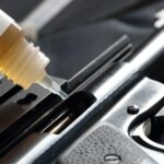 Close-up of a gun being lubricated with oil